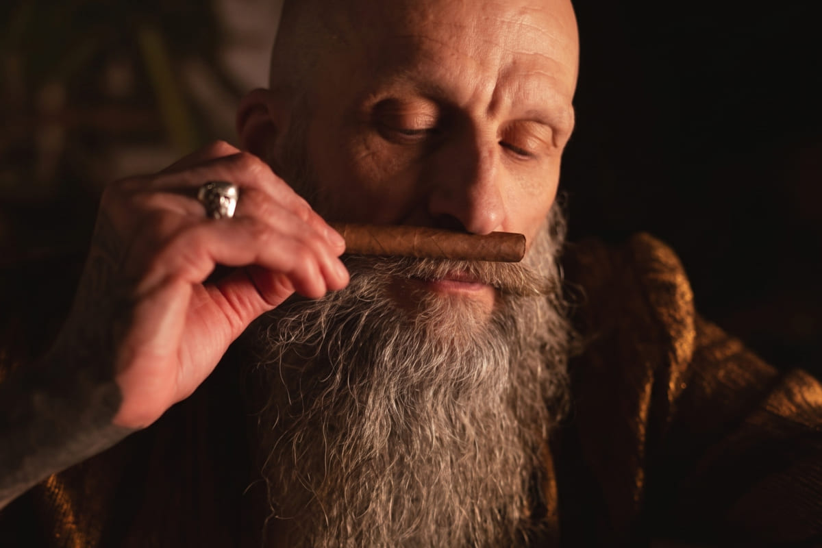 man smelling a cigar