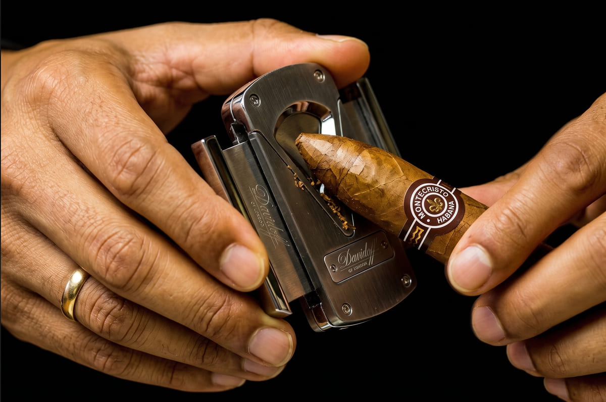 cigar being cut with a cutter
